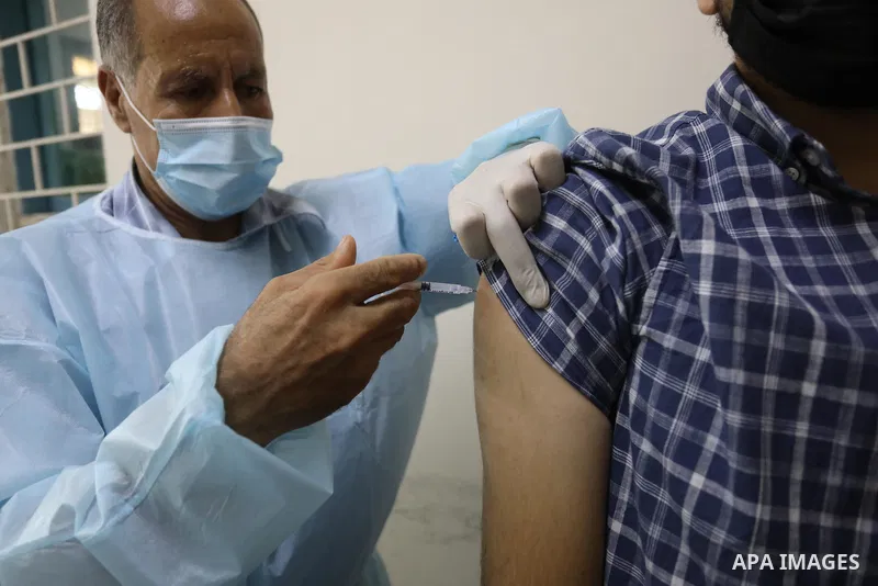 Palestinians get inoculated with a dose of the Covishield vaccine against the Covid-19 coronavirus, at a temporary vaccination centre set up, in Deir Al Balah in the center of Gaza strip on August 26, 2021. Minister of H...