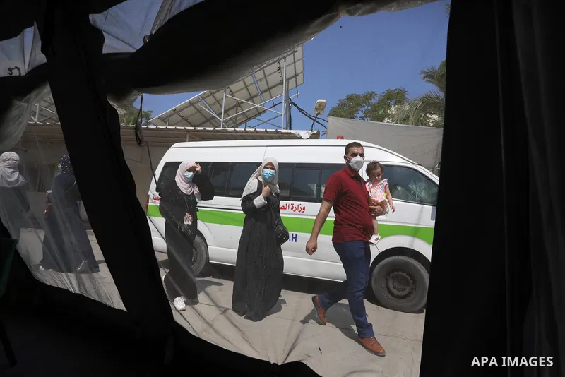 Palestinians get inoculated with a dose of the Covishield vaccine against the Covid-19 coronavirus, at a temporary vaccination centre set up, in Deir Al Balah in the center of Gaza strip on August 26, 2021. Minister of H...