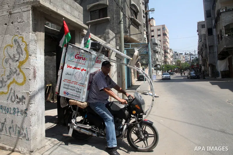 Palestinian Daoud Al-Bouji, 46, from Gaza sells pastries using a mobile bakery called "Six Girls food", at the streets of Al-Shati refugee camp, west of Gaza City, to force unemployment, on August 26, 2021. According to...