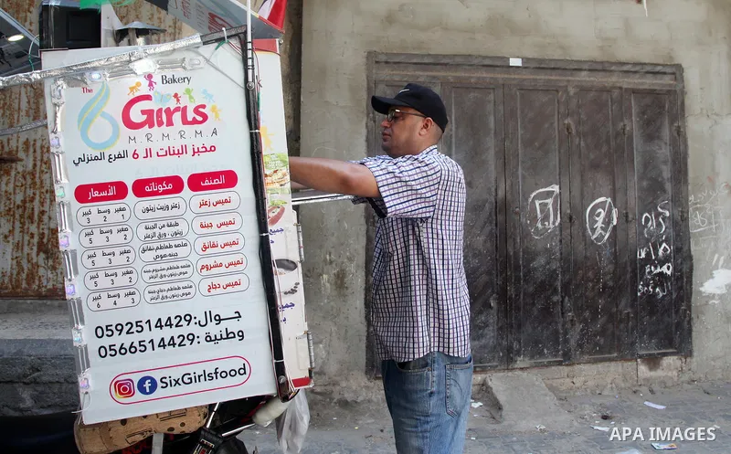 Palestinian Daoud Al-Bouji, 46, from Gaza sells pastries using a mobile bakery called "Six Girls food", at the streets of Al-Shati refugee camp, west of Gaza City, to force unemployment, on August 26, 2021. According to...