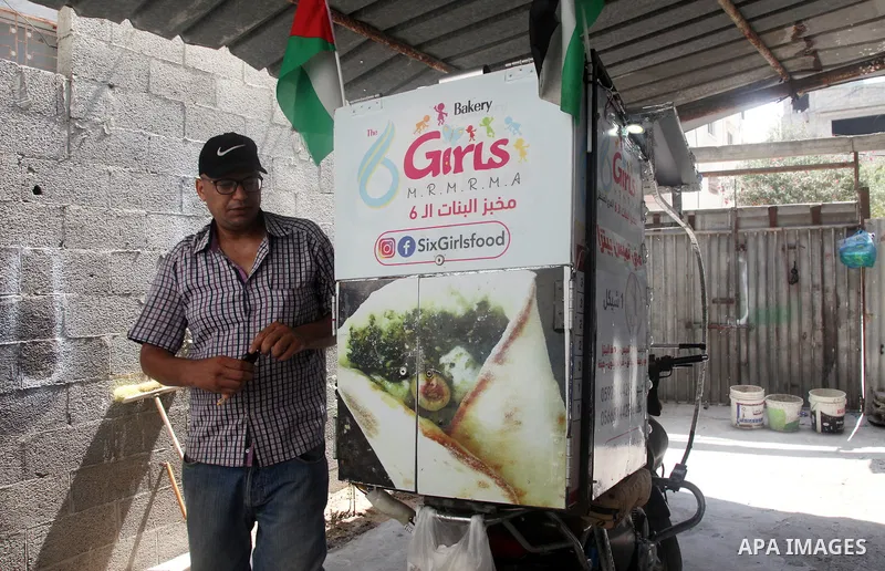Palestinian Daoud Al-Bouji, 46, from Gaza sells pastries using a mobile bakery called "Six Girls food", at the streets of Al-Shati refugee camp, west of Gaza City, to force unemployment, on August 26, 2021. According to...