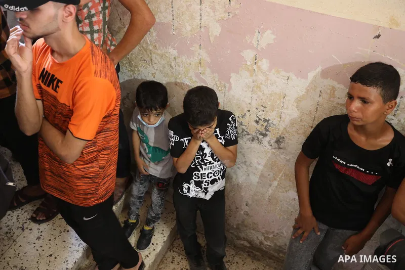 Palestinian mourners carry the body of teen Omar Abu al-Neal, who died of a wound he sustained during an anti-Israel protest at the Israel-Gaza border fence last week, during his funeral in Gaza city on August 28, 2021....