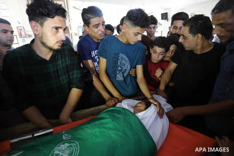 Palestinian mourners carry the body of teen Omar Abu al-Neal, who died of a wound he sustained during an anti-Israel protest at the Israel-Gaza border fence last week, during his funeral in Gaza city on August 28, 2021....