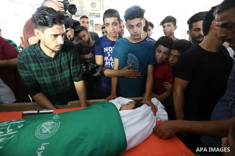 Palestinian mourners carry the body of teen Omar Abu al-Neal, who died of a wound he sustained during an anti-Israel protest at the Israel-Gaza border fence last week, during his funeral in Gaza city on August 28, 2021....