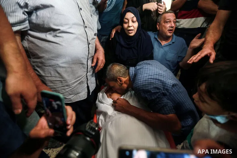 The mother of Palestinian teen Omar Abu Neal, 13, mourns over his body during his funeral in Gaza city on August 28, 2021. Abu Neal is the second Palestinian to die of wounds sustained during the same activity held marki...