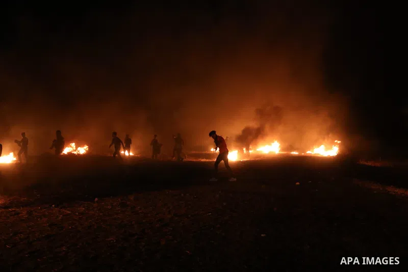Members of Palestinian protesters calling themselves the "night confusion units", burns tires as they gather near the Gaza-Israel border east of Gaza city, August 28, 2019. Hundreds of Palestinian protesters, have been o...