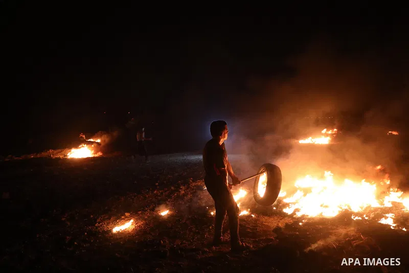 Members of Palestinian protesters calling themselves the "night confusion units", burns tires as they gather near the Gaza-Israel border east of Gaza city, August 28, 2019. Hundreds of Palestinian protesters, have been o...