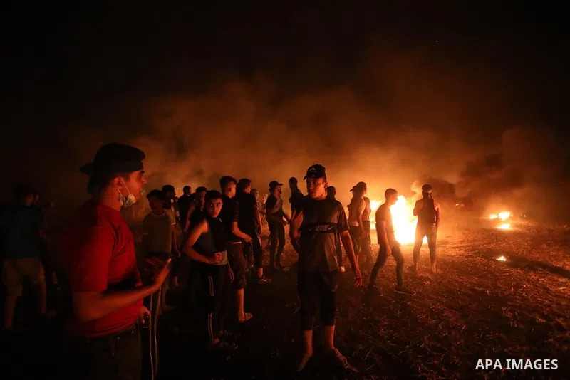 Members of Palestinian protesters calling themselves the "night confusion units", burns tires as they gather near the Gaza-Israel border east of Gaza city, August 28, 2019. Hundreds of Palestinian protesters, have been o...