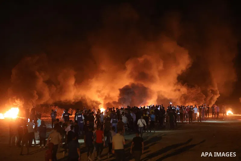 Members of Palestinian protesters calling themselves the "night confusion units", burns tires as they gather near the Gaza-Israel border east of Gaza city, August 28, 2019. Hundreds of Palestinian protesters, have been o...