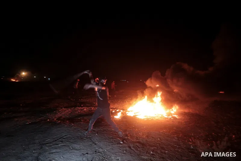 Members of Palestinian protesters calling themselves the "night confusion units", burns tires as they gather near the Gaza-Israel border east of Gaza city, August 28, 2019. Hundreds of Palestinian protesters, have been o...