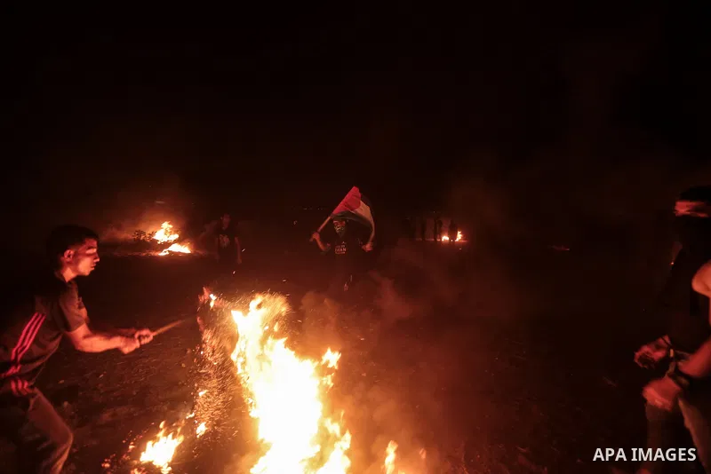Members of Palestinian protesters calling themselves the "night confusion units", burns tires as they gather near the Gaza-Israel border east of Gaza city, August 28, 2019. Hundreds of Palestinian protesters, have been o...