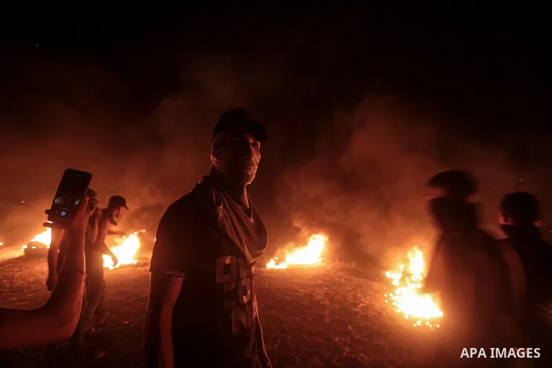 Members of Palestinian protesters calling themselves the "night confusion units", burns tires as they gather near the Gaza-Israel border east of Gaza city, August 28, 2019. Hundreds of Palestinian protesters, have been o...