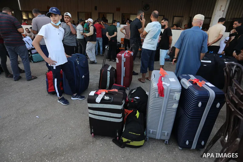 Palestinians wearing protective masks amid the COVID-19 pandemic, as they wait for travel permits to cross into Egypt through the Rafah border crossing, in Rafah in the southern of Gaza Strip, on August 29, 2021. Egypt o...