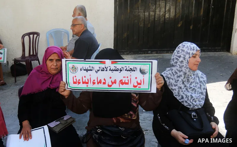 Families of Palestinian martyrs and wounded, take part in a protest against the Palestinian Authority's decision to cut their salaries for seven years, in Gaza City on August 31, 2021. In January 2019, the PA cut the sal...