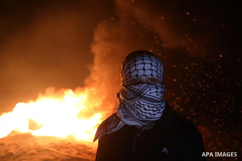 Palestinians burn tires during night protest along the border fence with Israel, east of al-Bureij refugee camp in the central Gaza Strip, on August 31, 2021. Palestinians demanding an end to Israel's blockade and the ri...
