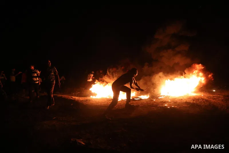 Palestinians burn tires during night protest along the border fence with Israel, east of al-Bureij refugee camp in the central Gaza Strip, on August 31, 2021. Palestinians demanding an end to Israel's blockade and the ri...