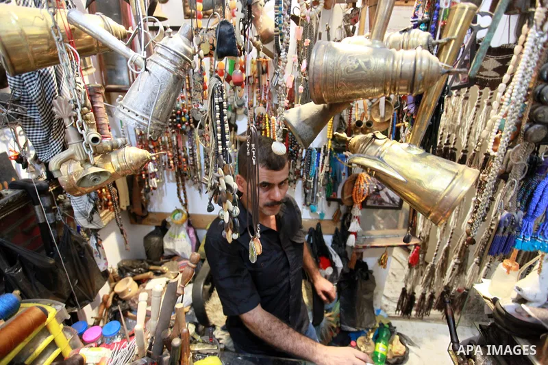 A Palestinian seller displays old copper coins and dozens of valuable antiques, at his Antica Store, in Gaza city on September 1, 2021. In the Gaza Strip, caring for antiquities is not common amid the high poverty and un...