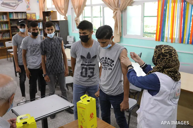 Palestinian students get inoculated with a dose of the Covishield vaccine against the Covid-19 coronavirus, at a school, in Nuseirat refugee camp in central Gaza Strip, on September 1, 2021. Palestinian health authoritie...