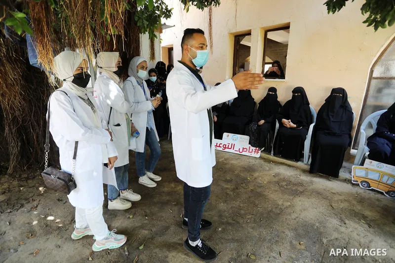 Palestinian medicals and activists participate during the "Awareness Bus" initiative to educate people about the Corona vaccine in poor areas, in Beit Lahia in the northern of Gaza Strip on September 2, 2021. Photo by As...