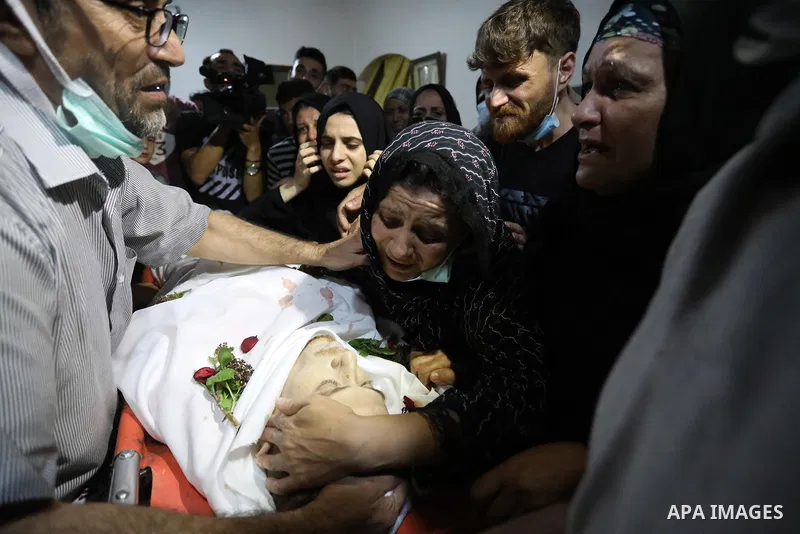 Mourners attend the funeral of Palestinian Ahmed Saleh, who was shot dead by Israeli troops during night clashes the Israeli-Gaza border fence, at Jabalia refugee camp northern Gaza Strip on September 3, 2021. Photo by A...
