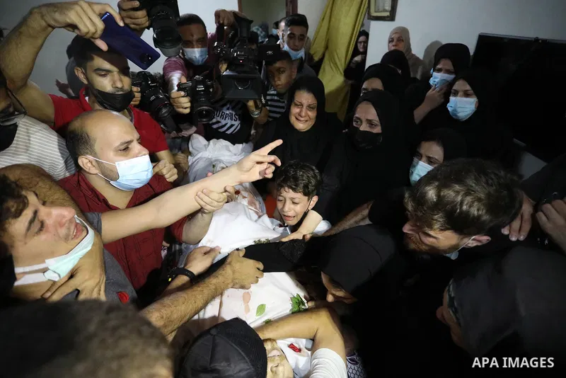 Mourners attend the funeral of Palestinian Ahmed Saleh, who was shot dead by Israeli troops during night clashes the Israeli-Gaza border fence, at Jabalia refugee camp northern Gaza Strip on September 3, 2021. Photo by A...