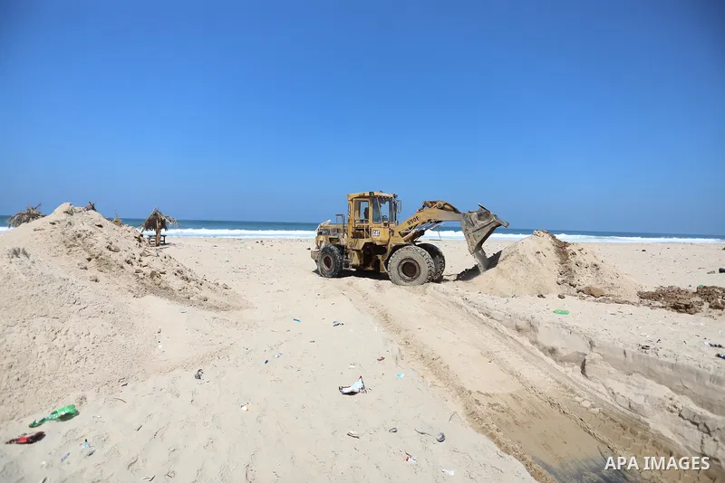 Palestinian workers build a corniche at the beach in the Mediterranean Sea in Deir al-Balah in the center of Gaza Strip on September 4, 2021. The beach is one of the few open public spaces in this densely populated city....