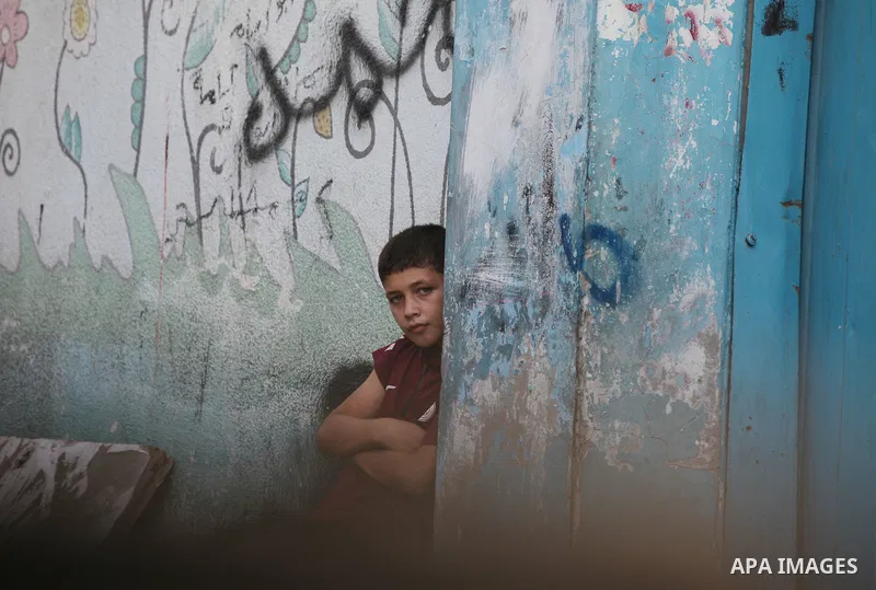 A Palestinian boy poses for a photo in al-Shati refugee camp, west of Gaza City, on September 5, 2021. Over the last 14 years, Gaza residents have endured four deadly Israeli attacks, rebuilding after each one and hoping...