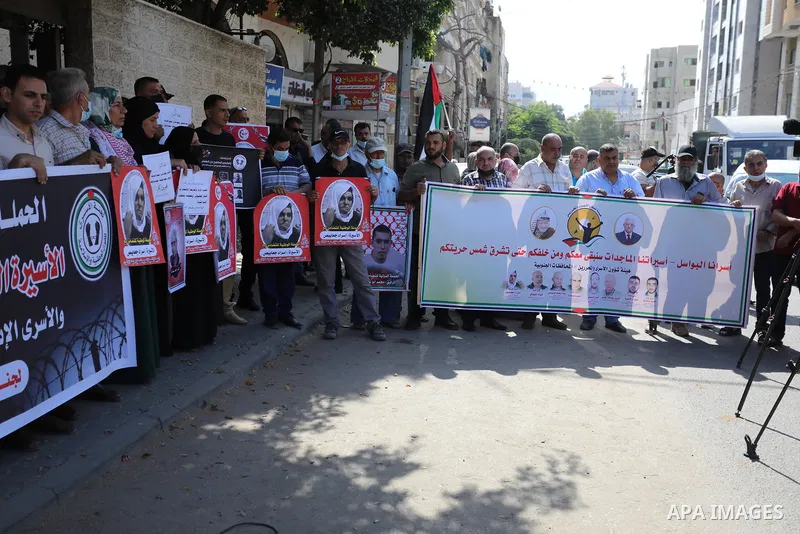 Palestinians celebrate after the escape of Six Palestinian prisoners, in front of Red Cross office in Gaza city, on Sebtember 6, 2021. ​Six Palestinian prisoners, most of them serving life term for resisting the Israeli...