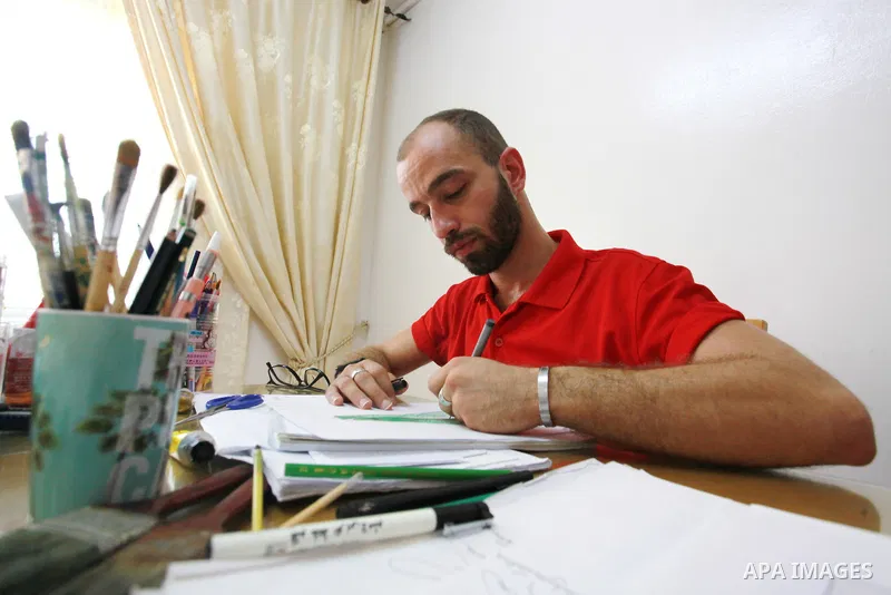 Palestinian fashion designer Yahya Hussein, 28, works on designs at his home, in Gaza city, on September 6, 2021. Hussein is the first men's fashion designer in the Gaza Strip. Thus, the unemployment rate among youth rea...