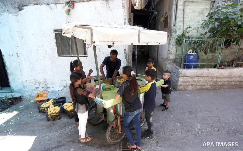 Palestinian man Mahran Hamadeh, 39, works on a mobile van selling corn at Balata refugees camp, east the West Bank city of Nablus, on September 7, 2021. Hamadeh works daily to help hisself and his family. Thus, the unemp...