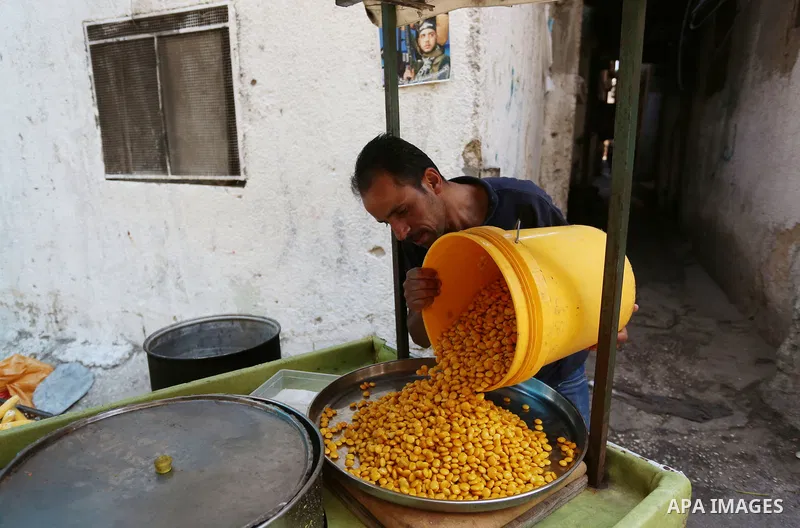 Palestinian man Mahran Hamadeh, 39, works on a mobile van selling corn at Balata refugees camp, east the West Bank city of Nablus, on September 7, 2021. Hamadeh works daily to help hisself and his family. Thus, the unemp...