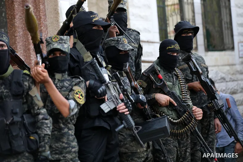 Palestinian militants from the Al-Quds Brigades, the armed wing of the Islamic Jihad movement, take part in a military parade, in support of prisoners held in Israeli jails in Deir al-Balah in the center of Gaza Strip, o...