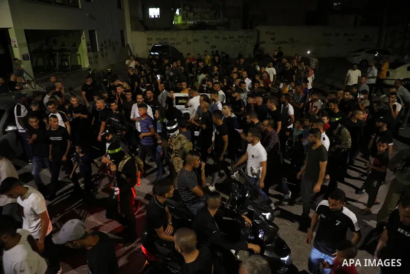 Masked Palestinian gunmen hold their weapons during a protest in support of Palestinian prisoners held in Israeli jails, in the West Bank city of Jenin, September 11, 2021. Two more of the six Gilboa prison freedom fight...