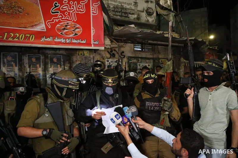 Masked Palestinian gunmen hold their weapons during a protest in support of Palestinian prisoners held in Israeli jails, in the West Bank city of Jenin, September 11, 2021. Two more of the six Gilboa prison freedom fight...