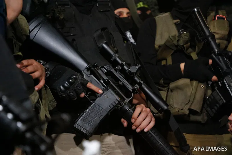 Masked Palestinian gunmen hold their weapons during a protest in support of Palestinian prisoners held in Israeli jails, in the West Bank city of Jenin, September 11, 2021. Two more of the six Gilboa prison freedom fight...
