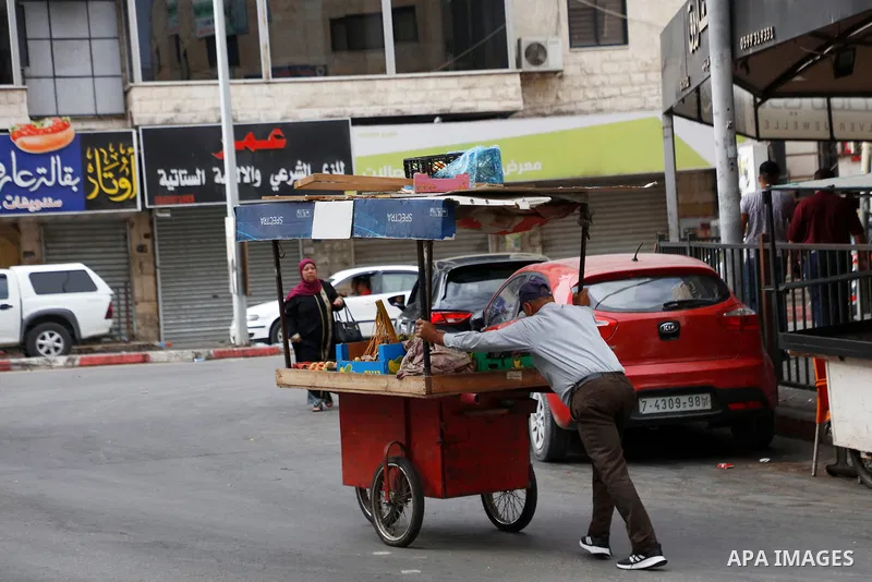 Palestinians walk past closed shops during a general strike in support of prisoners who were arrested following their escape from Gilboa prison, in the West Bank city of Jenin on September 12, 2021. Yesterday, thousands...