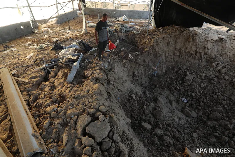 A Palestinian inspects the site of an Israeli airstrike following the Palestinian rocket fire into Israel, in Rafah in the southern of Gaza Strip, on September 12, 2021. Israel carried out air strikes in the Gaza Strip o...