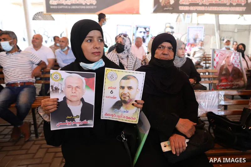 Palestinians take part in a protest to solidarity with prisoners who were arrested following their escape from Gilboa prison, in front of Red Cross office, in Gaza city, on September 13, 2021. The four Palestinian prison...