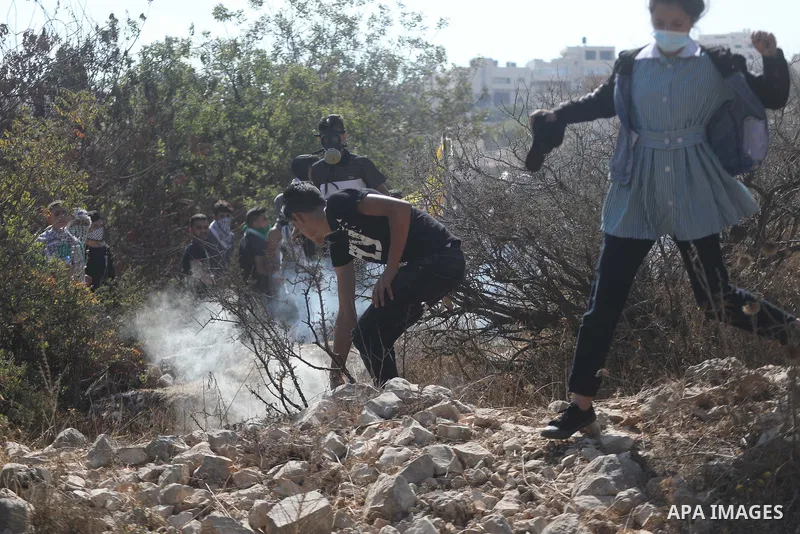Palestinian students clash with Israeli forces during a protest in support of the six Palestinian prisoners who escaped from Israel's Gilboa prison, in the West Bank city of Hebron on September 14, 2021. That clashes eru...