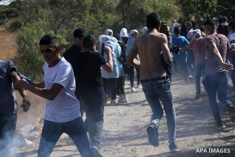 Palestinian students clash with Israeli forces during a protest in support of the six Palestinian prisoners who escaped from Israel's Gilboa prison, in the West Bank city of Hebron on September 14, 2021. That clashes eru...
