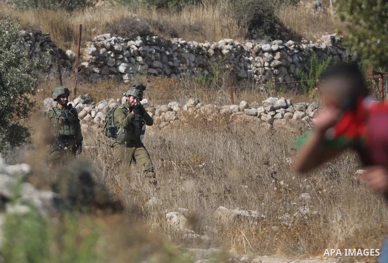 Palestinian students clash with Israeli forces during a protest in support of the six Palestinian prisoners who escaped from Israel's Gilboa prison, in the West Bank city of Hebron on September 14, 2021. That clashes eru...