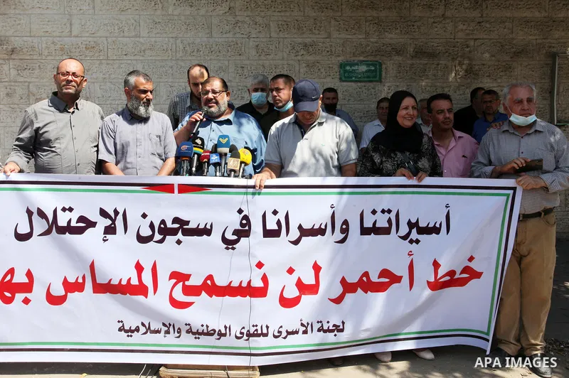 Palestinians attend a press conference in solidarity with prisoners in Israeli jails, in front of Red cross office in Gaza city, on September 15, 2021. Israel has recaptured four of the six Palestinian militants who esca...