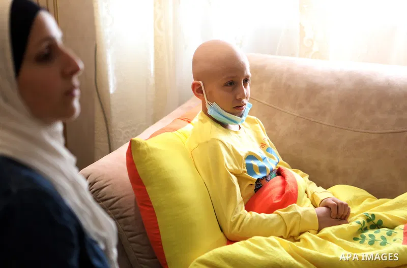 A Palestinian cancer-stricken child, Ahmad Qawasmeh, who Israeli forces detained his father, sits inside his family home in the West Bank city of Hebron on 16, 2021. Israeli forces detained 37-year-old father-of-four, Hi...