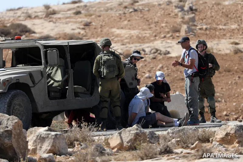Israeli soldiers detain Palestinians and foreign activists during a demonstration against Israeli land confiscation and the cutting water supply for Palestinians villages, in the southern area of the West bank town of He...