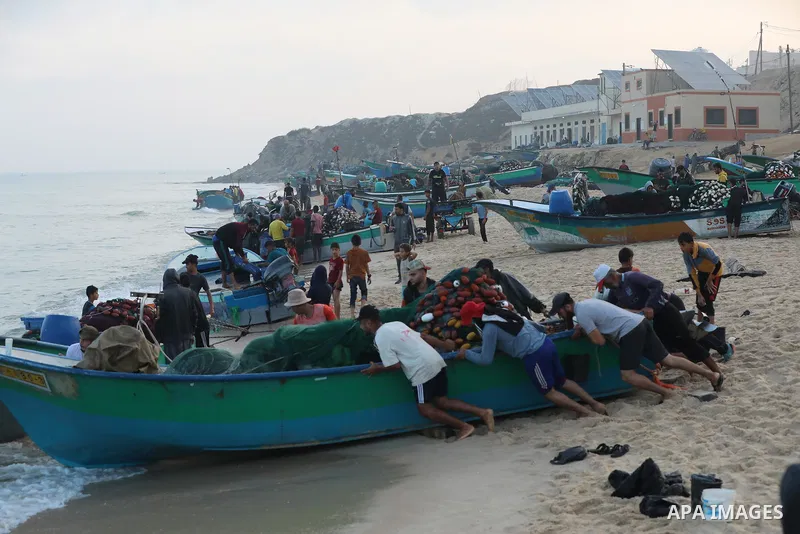 Palestinian fishermen work on the shore of the Mediterranean Sea, in Deir El-Balah, in the center of Gaza strip, on September 21, 2021. Fishing is a major source of revenue for the impoverished Palestinian enclave. Israe...