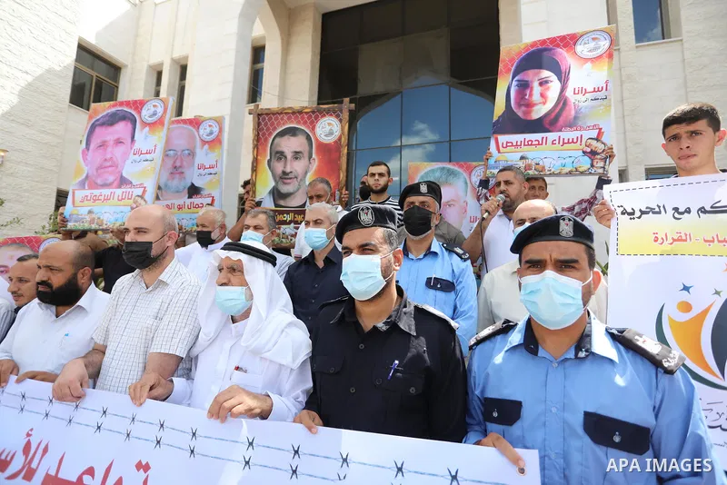 Palestinians take part in a protest to show solidarity with prisoners in Israeli Jails, in Khan Younis in the southern of Gaza strip, on September 23, 2021. The Prisoners’ Affairs Commission announced in a press statemen...