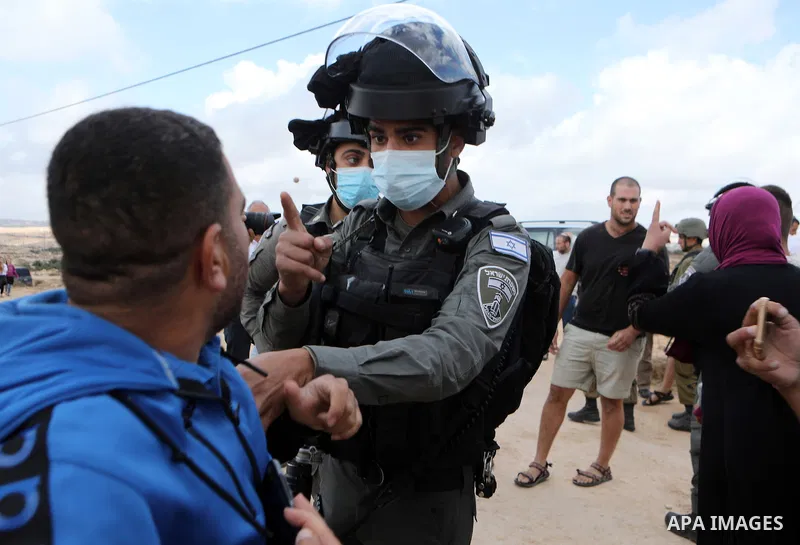 Israeli security forces stop Palestinians from the village of Susya during scuffles with Jewish settlers from the settlement of the same name, as a group of representatives of the European Union visit the area C (under I...