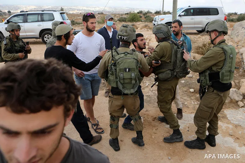 Israeli security forces scuffle with Jewish settlers from the settlement of Susya as they try to attack Palestinians from the village of the same name, during the visit of a group of representatives of the European Union...