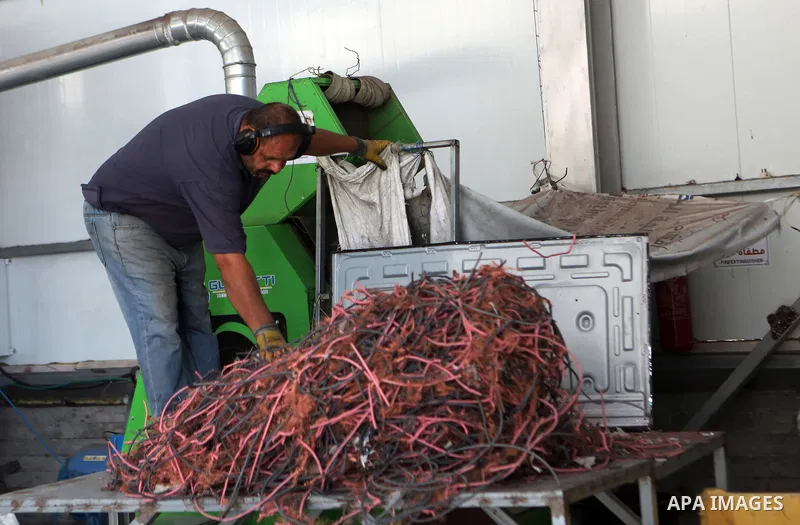 Palestinian workers reuse electronic waste it using modern, environmentally friendly scientific methods at a factory, in the West Bank city of Hebron, on September 25, 2021. Photo by Mamoun Wazwaz