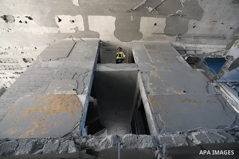 Palestinian workers use a bulldozer to remove the rubbles of al-Jawhara tower which was hit by Israeli strikes during the recent 11-day conflict between Israel and Hamas on May, in Gaza city on September 26, 2021. The to...